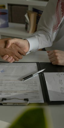two-people-shaking-hands-over-a-piece-of-paper.jpg two people shaking hands over a piece of paper